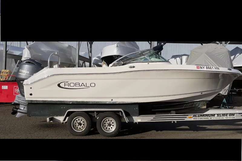 The Image of 2022 Robalo R207 Dual Console boat on trailer, side view. - 0
