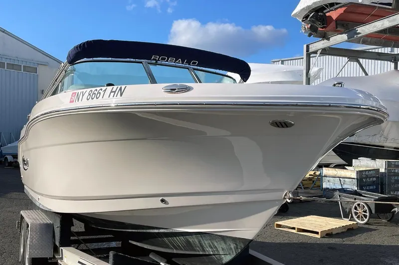 Slide: The Image of 2022 Robalo R207 Dual Console boat on trailer, dockside view. - 2