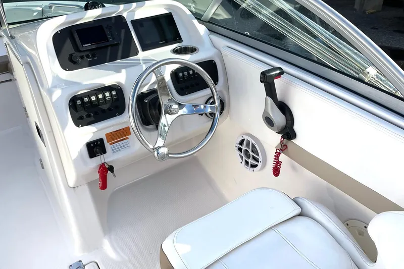 Slide: The Image of 2022 Robalo R207 Dual Console boat cockpit with steering wheel and control panel. - 3