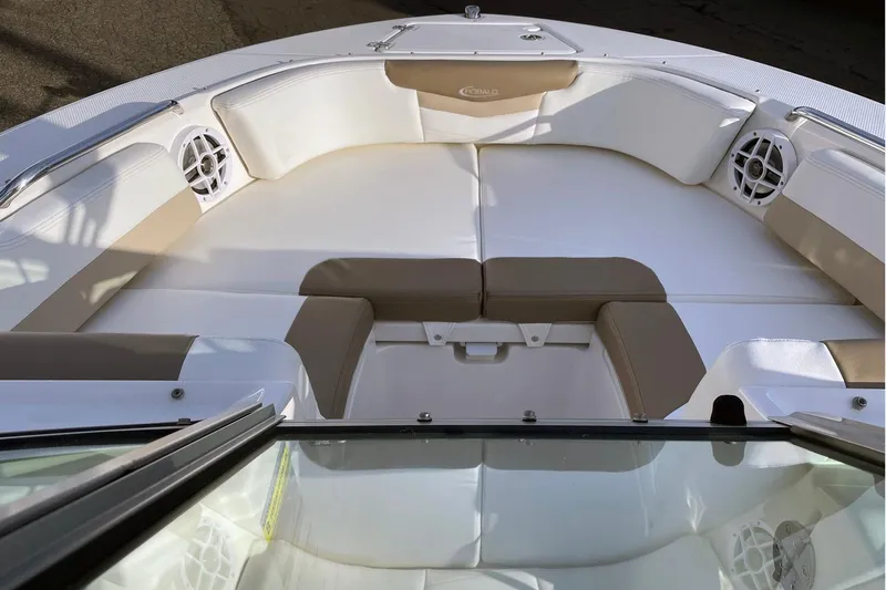 Slide: The Image of 2022 Robalo R207 Dual Console boat interior with cushioned seating and speakers. - 4