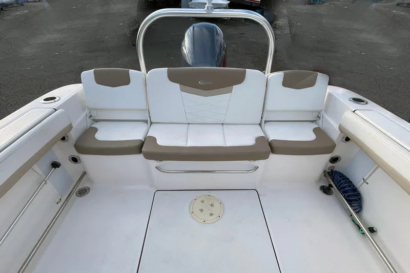 Slide: The Image of 2022 Robalo R207 Dual Console boat interior with cushioned seating and storage. - 5