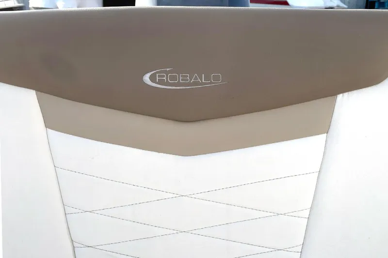 Slide: The Image of 2022 Robalo R207 Dual Console boat seat with logo, beige and white upholstery. - 6