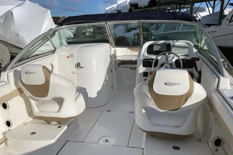 Slide: The Image of 2022 Robalo R207 Dual Console boat interior with steering wheel and seating. - 7