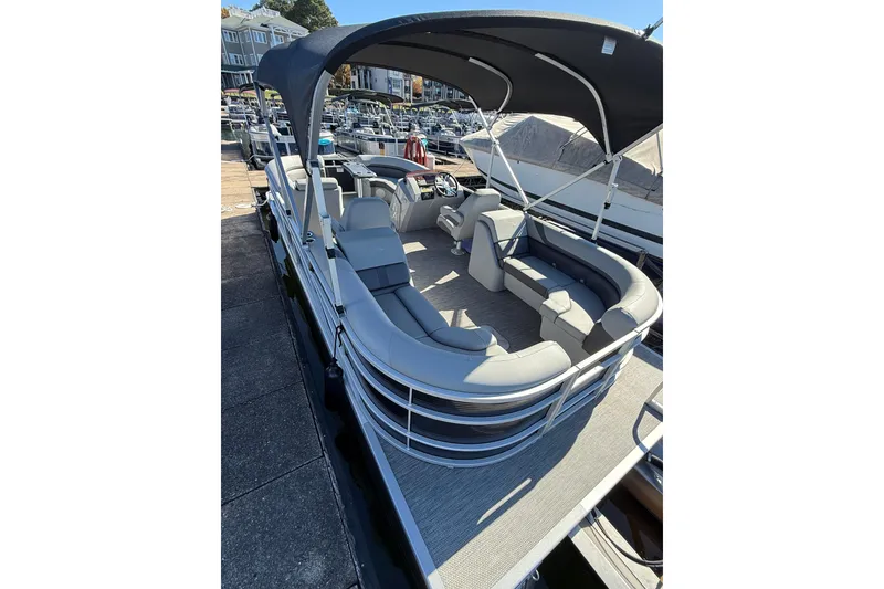 Slide: The Image of 2023 Bennington 22SX Stern Radius pontoon boat with canopy, docked at marina. - 8