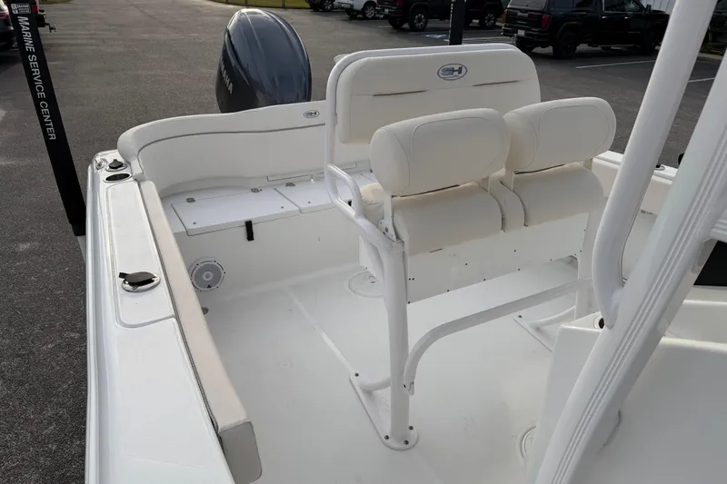 Slide: The Image of 2024 Sea Hunt Ultra 229 boat interior with white seating and clean deck design. - 13