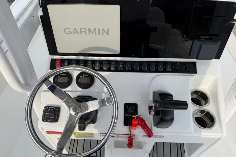 Slide: The Image of 2024 Sea Hunt Ultra 229 boat dashboard with Garmin display and Yamaha controls. - 16
