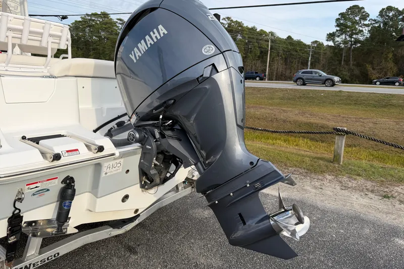 Slide: The Image of 2024 Sea Hunt Ultra 229 boat with Yamaha outboard motor, parked on a trailer. - 21