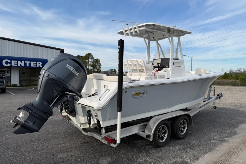 Slide: The Image of 2024 Sea Hunt Ultra 229 boat with Yamaha engine on trailer, parked outside dealership. - 6