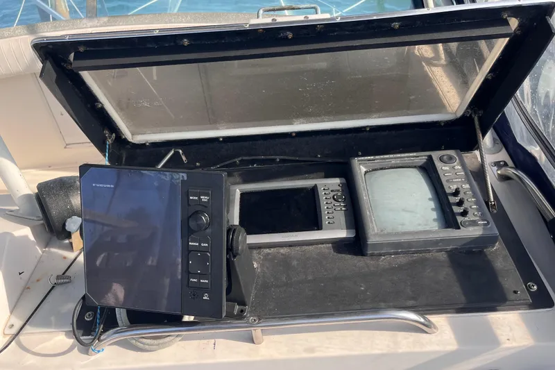 Slide: The Image of 1981 Bertram 35 Sportfish boat dashboard with navigation equipment and controls. - 10