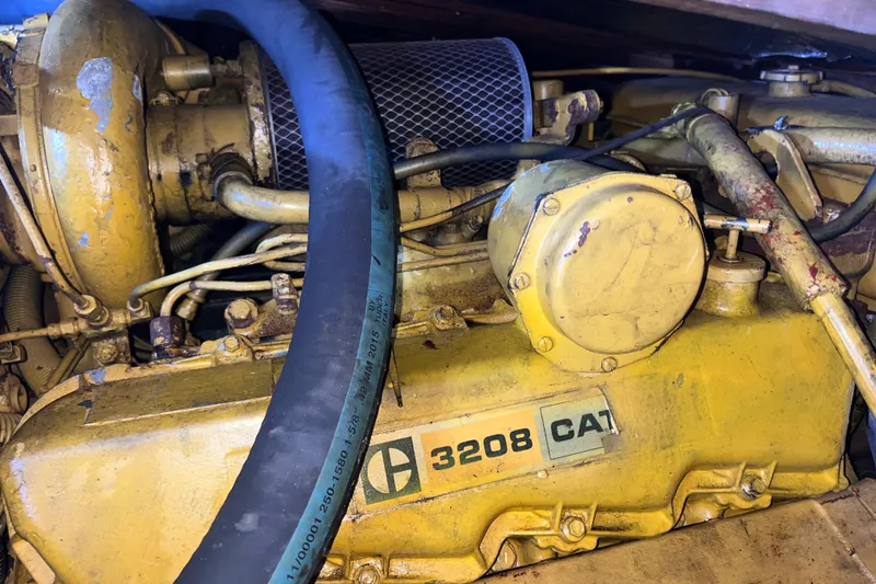 Slide: The Image of Caterpillar 3208 engine in a 1981 Bertram 35 Sportfish boat, showing detailed components. - 12