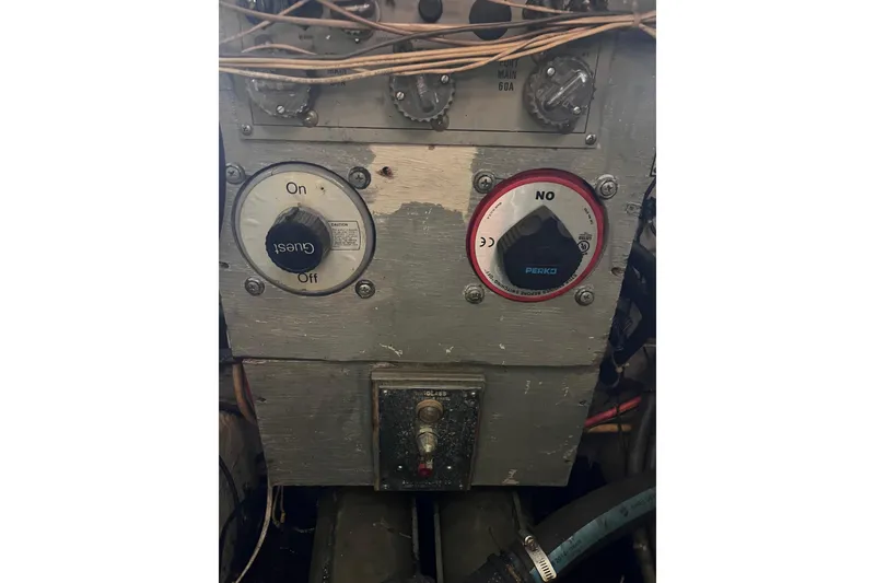 Slide: The Image of Control panel of a 1981 Bertram 35 Sportfish boat with switches and wiring. - 14