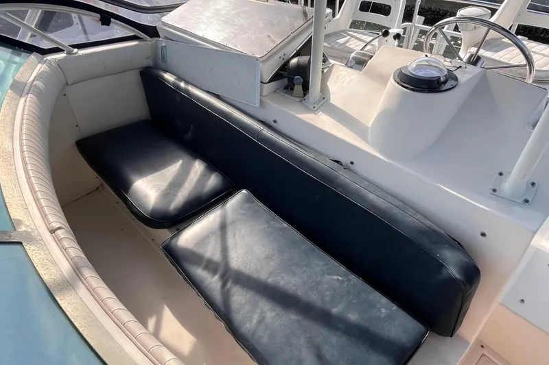 Slide: The Image of 1981 Bertram 35 Sportfish boat interior with blue seating and steering console. - 15