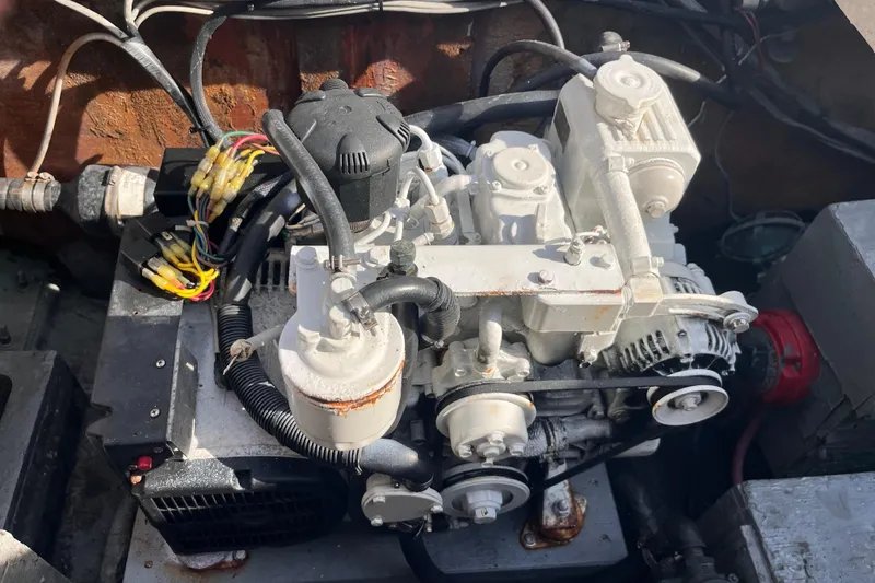 Slide: The Image of Engine compartment of a 1981 Bertram 35 Sportfish boat, showcasing mechanical components. - 16