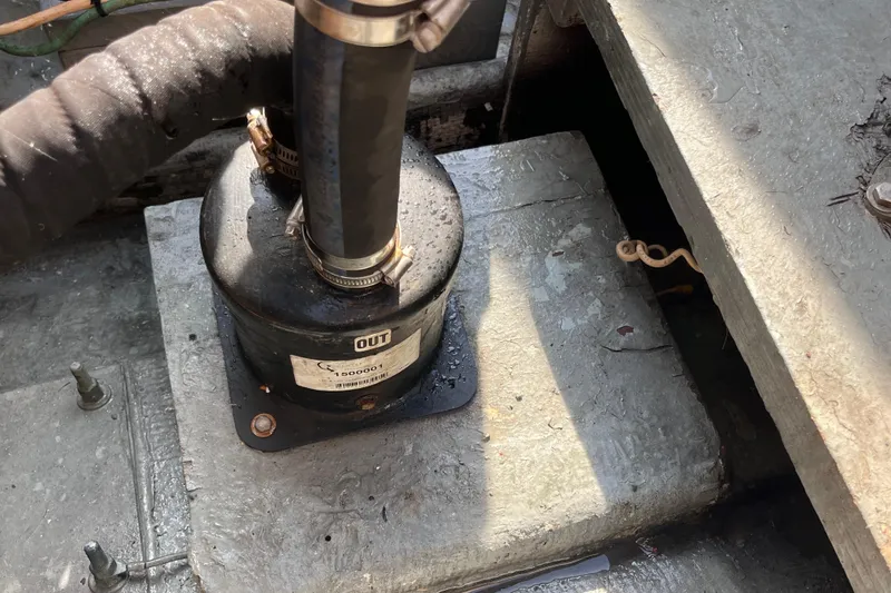 Slide: The Image of Engine component of 1981 Bertram 35 Sportfish boat, featuring a black cylindrical part. - 18