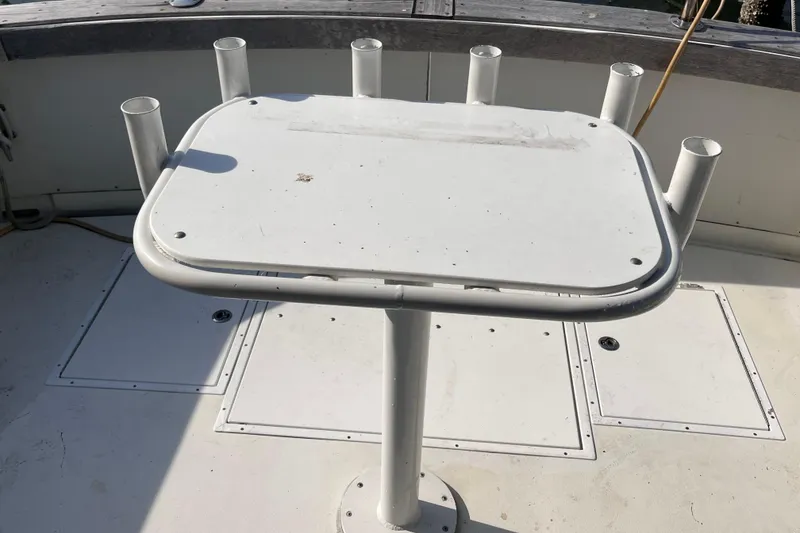 Slide: The Image of 1981 Bertram 35 Sportfish cockpit with fishing rod holders and table. - 21