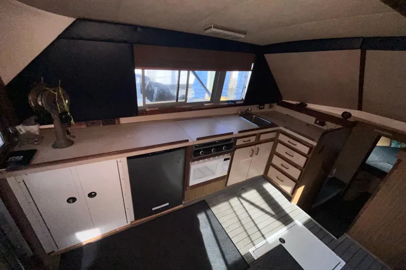Slide: The Image of 1981 Bertram 35 Sportfish interior kitchen with wooden cabinets and modern appliances. - 28
