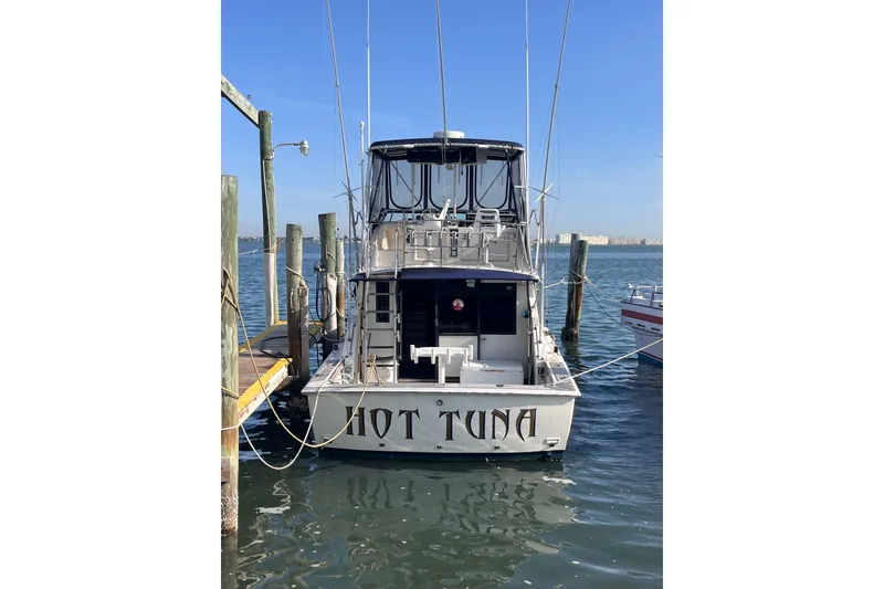 Slide: The Image of 1981 Bertram 35 Sportfish boat named "Hot Tuna" docked at a marina. - 3