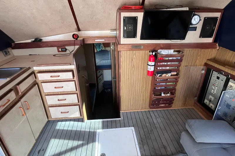 Slide: The Image of Interior of a 1981 Bertram 35 Sportfish boat with kitchen and storage. - 33