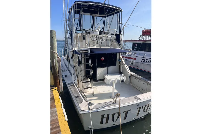 Slide: The Image of 1981 Bertram 35 Sportfish boat docked at marina, rear view. - 4