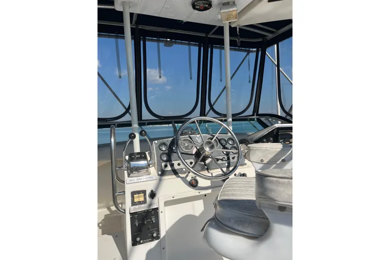 Slide: The Image of Cockpit of 1981 Bertram 35 Sportfish boat with steering wheel and controls. - 8