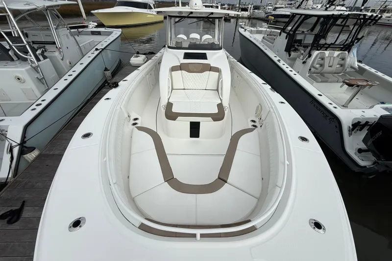 Slide: The Image of 2020 Edgewater 370CC boat docked, featuring spacious seating and sleek design. - 1