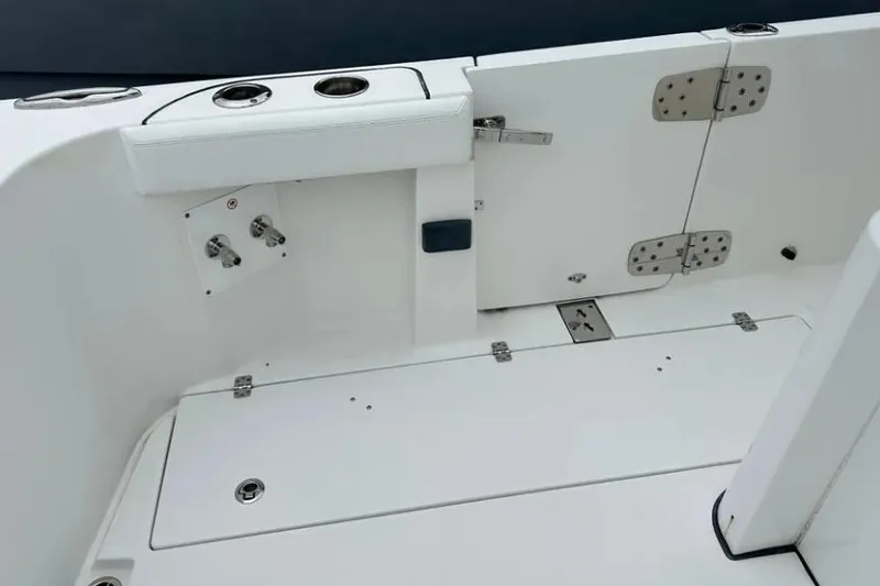 Slide: The Image of 2020 Edgewater 370CC boat interior with white deck and storage compartments. - 14