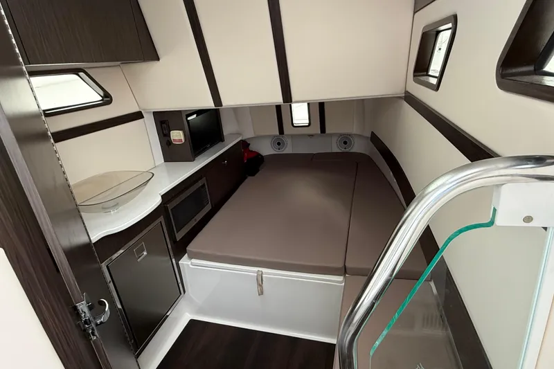 Slide: The Image of Interior of 2020 Edgewater 370CC boat with bed, kitchenette, and modern design. - 15