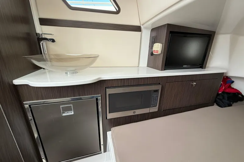 Slide: The Image of 2020 Edgewater 370CC cabin interior with sink, microwave, and TV. - 17