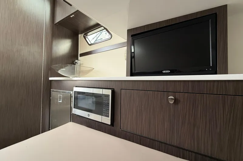 Slide: The Image of 2020 Edgewater 370CC interior with TV, microwave, and modern sink. - 18