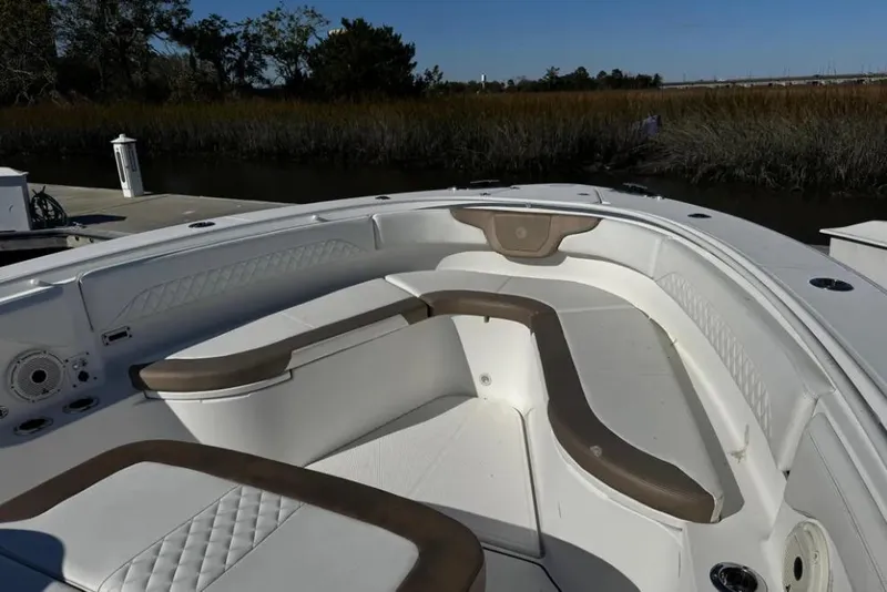 Slide: The Image of 2020 Edgewater 370CC boat interior with cushioned seating and speaker system. - 3