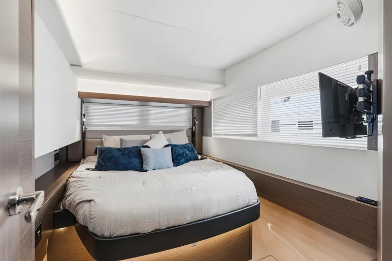 Slide: The Image of 2025 Leopard 53 Powercat interior with modern laundry area and bedroom view. - 28