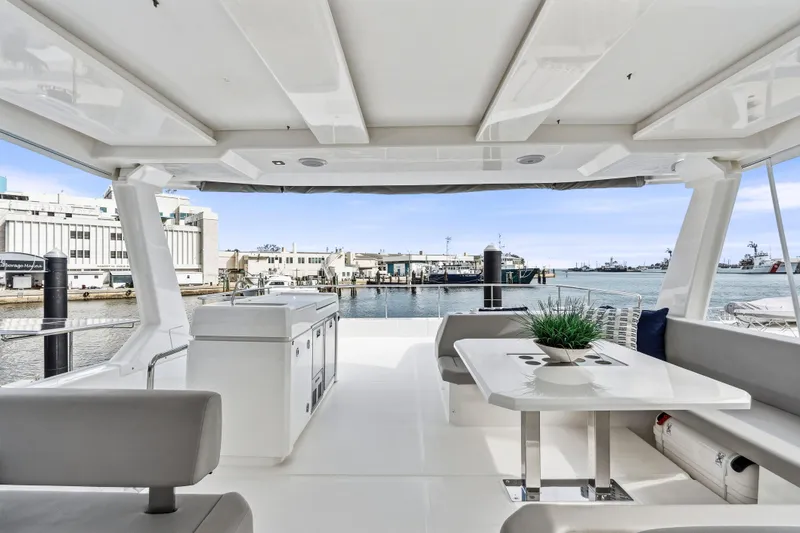 Slide: The Image of 2025 Leopard 53 Powercat yacht docked in a marina, surrounded by other boats. - 41