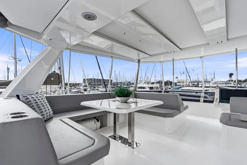 Slide: The Image of Helm of 2025 Leopard 53 Powercat with modern navigation systems, steering wheel, and ocean view. - 44