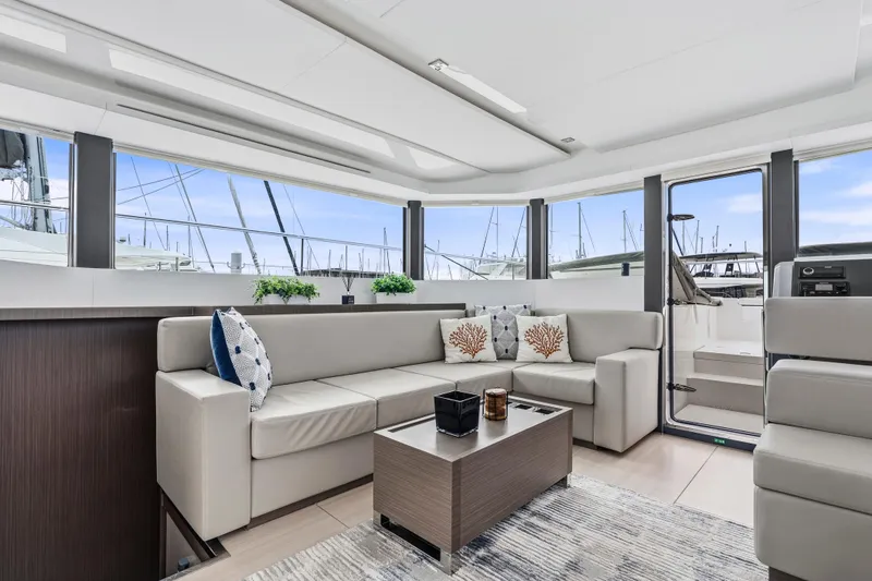 Slide: The Image of 2025 Leopard 53 Powercat cruising on open water, city skyline in background. - 7