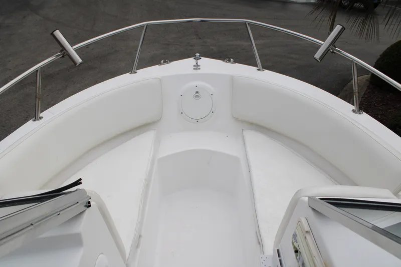 Slide: The Image of 2005 Edgewater 185DC boat bow with white seating and stainless steel railings. - 12