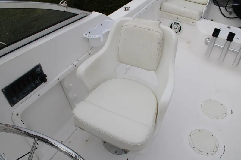 Slide: The Image of White captain's chair on 2005 Edgewater 185DC boat, featuring control panel and steering wheel. - 15