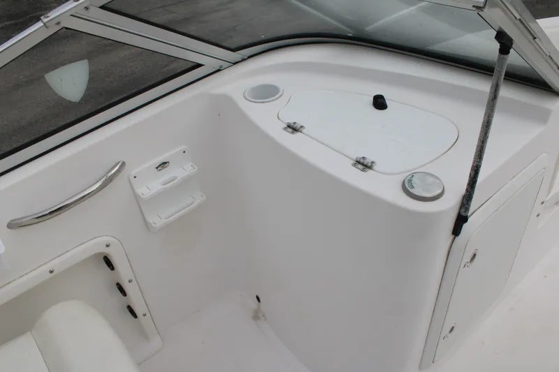Slide: The Image of 2005 Edgewater 185DC boat interior with storage compartments and seating area. - 17
