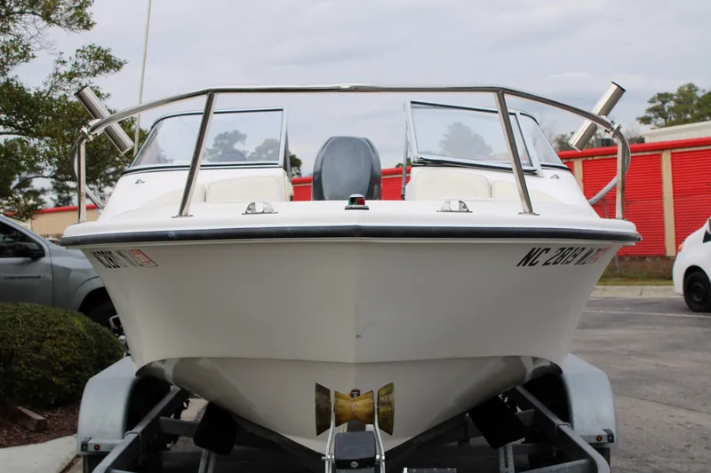 Slide: The Image of 2005 Edgewater 185DC boat on trailer, front view, parked outdoors. - 2