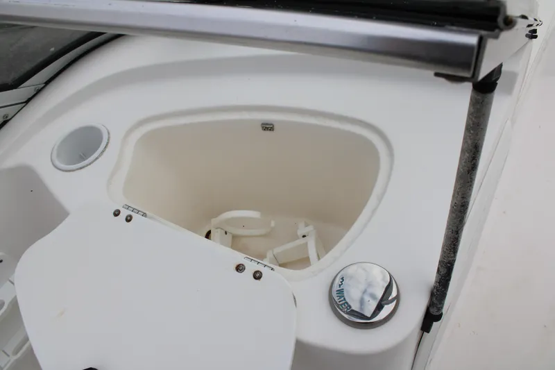 Slide: The Image of Edgewater 185DC 2005 boat storage compartment with open lid and water fill cap. - 22