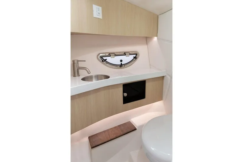 Slide: The Image of Manufacturer Provided Image: 2026 Regal LX9 boat bathroom with modern sink, faucet, and porthole window. - 10