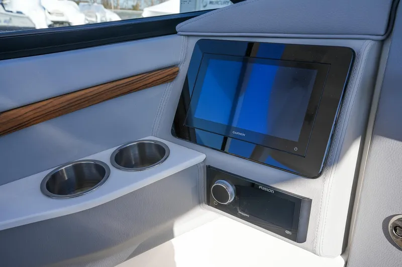 Slide: The Image of 2026 Regal LX9 boat interior with Garmin display and dual cup holders. - 17