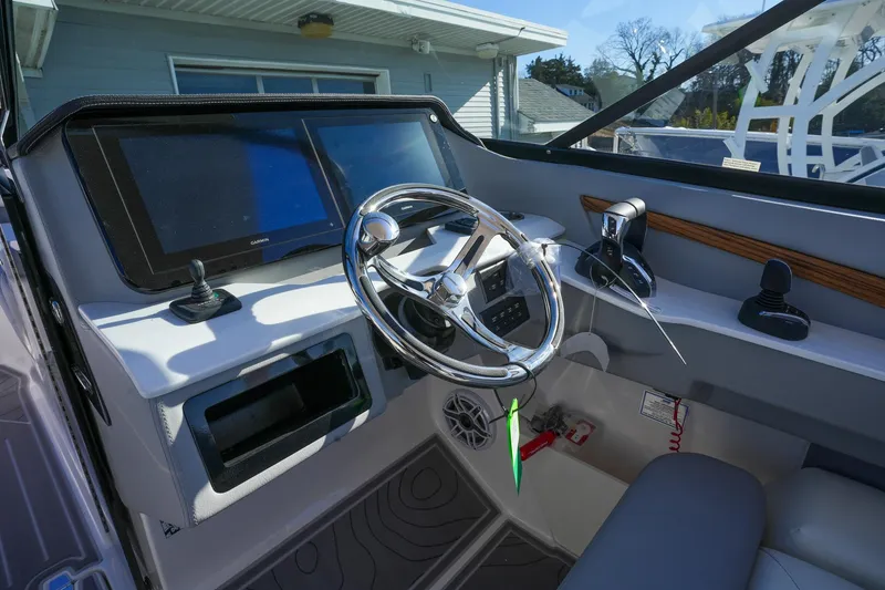 Slide: The Image of 2026 Regal LX9 boat dashboard with steering wheel and dual displays. - 20