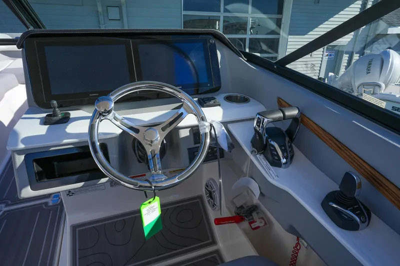 Slide: The Image of 2026 Regal LX9 boat cockpit with steering wheel, dual screens, and control panel. - 21