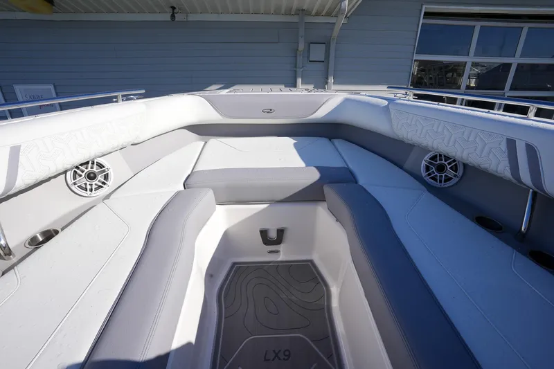 Slide: The Image of 2026 Regal LX9 boat interior with cushioned seating and built-in speakers. - 22