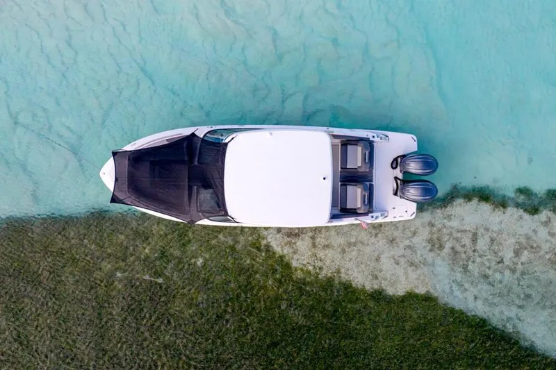 Slide: The Image of Manufacturer Provided Image: Aerial view of 2026 Regal LX9 boat on clear turquoise water. - 4