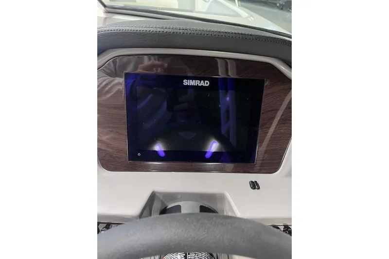 Slide: The Image of Dashboard of 2025 Chaparral 23 SSi boat featuring a Simrad display screen. - 11