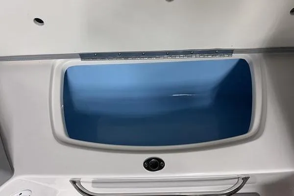 Slide: The Image of 2025 Chaparral 23 SSi boat storage compartment with blue interior and sleek design. - 17