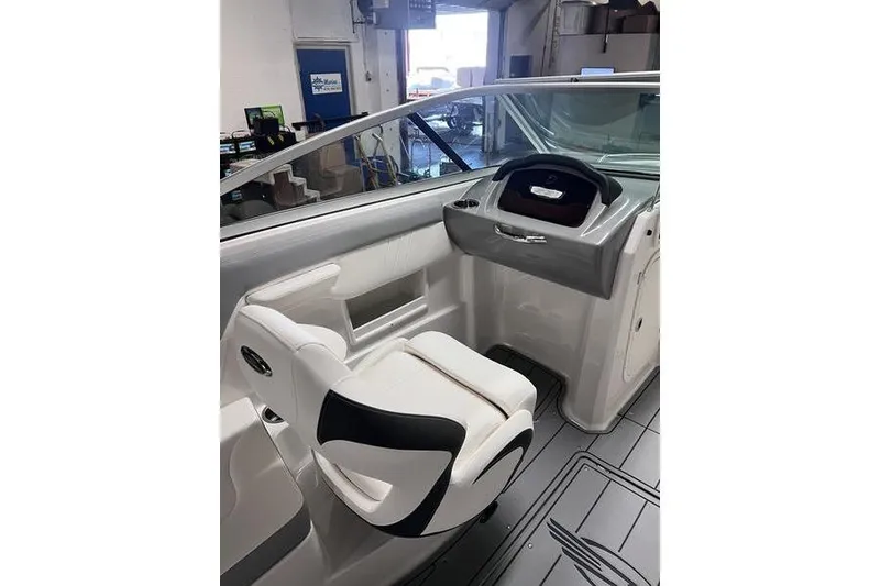 Slide: The Image of 2025 Chaparral 23 SSi boat interior with sleek helm and comfortable seating. - 8