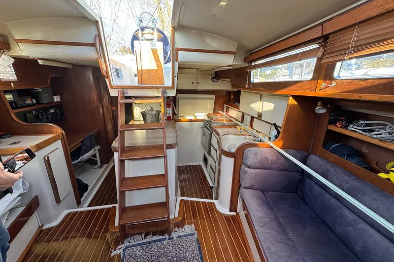 Slide: The Image of Interior of 1987 Irwin 38 Mk II sailboat with wooden finishes and cozy seating area. - 21