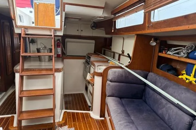 Slide: The Image of Interior of 1987 Irwin 38 Mk II sailboat with wooden finishes and cozy seating area. - 28